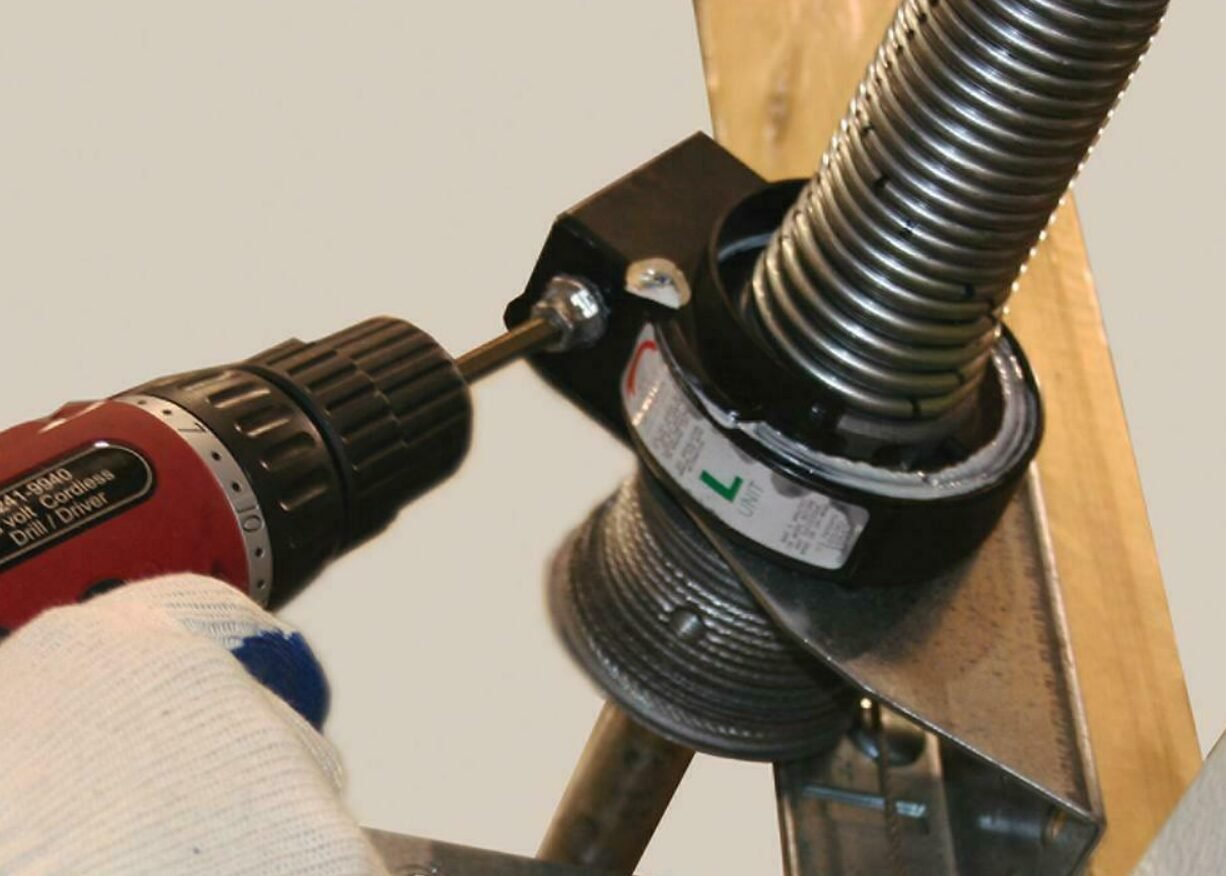 a professional technician performing garage door spring repair, ensuring the safety and functionality of residential garage doors in Whitehall. Expert services available at Whitehall Garage Door Repair.