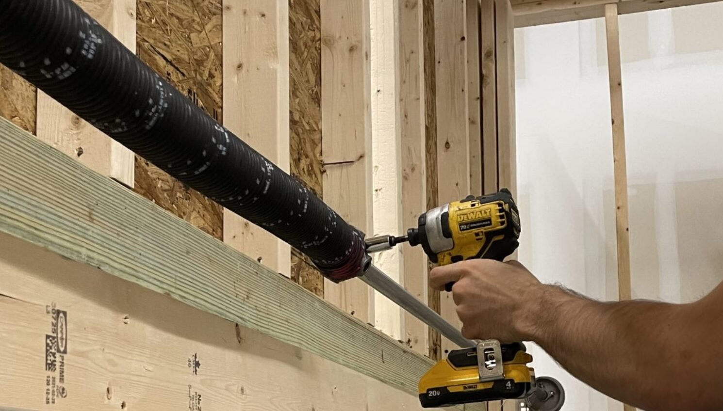 a technician performing garage door spring repair in Whitehall, showcasing the precise tools and expertise involved in fixing and maintaining garage door systems for reliable functionality.