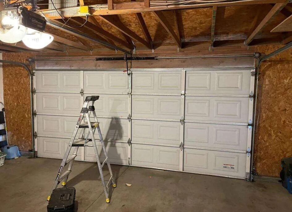 Professional technician performing garage door repair services at a residential property, showcasing high-quality repair tools and equipment - Whitehall Garage Door Repair