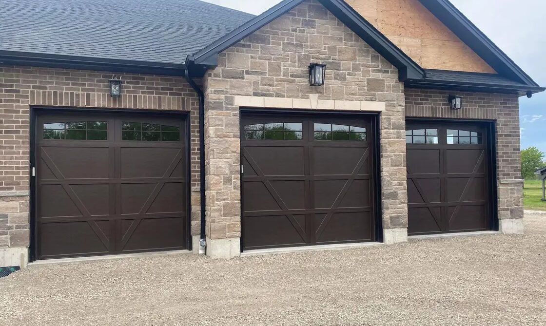 A professional technician from Whitehall Garage Door Repair expertly replacing a broken spring on a residential garage door. The technician is using specialized tools to ensure the repair is done safely and efficiently. The image captures the precision and expertise involved in quality garage door repair services.