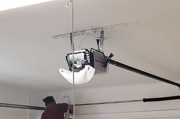 a professional technician performing garage door opener repair, showcasing expert service available at Whitehall Garage Door Repair.
