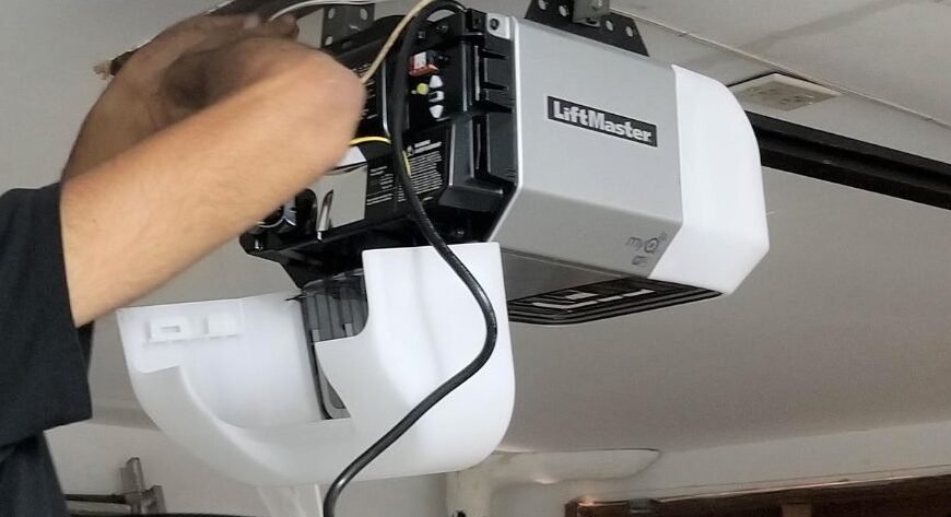 "Image of a technician repairing a garage door opener with tools in hand to illustrate professional garage door opener repair services in Whitehall."